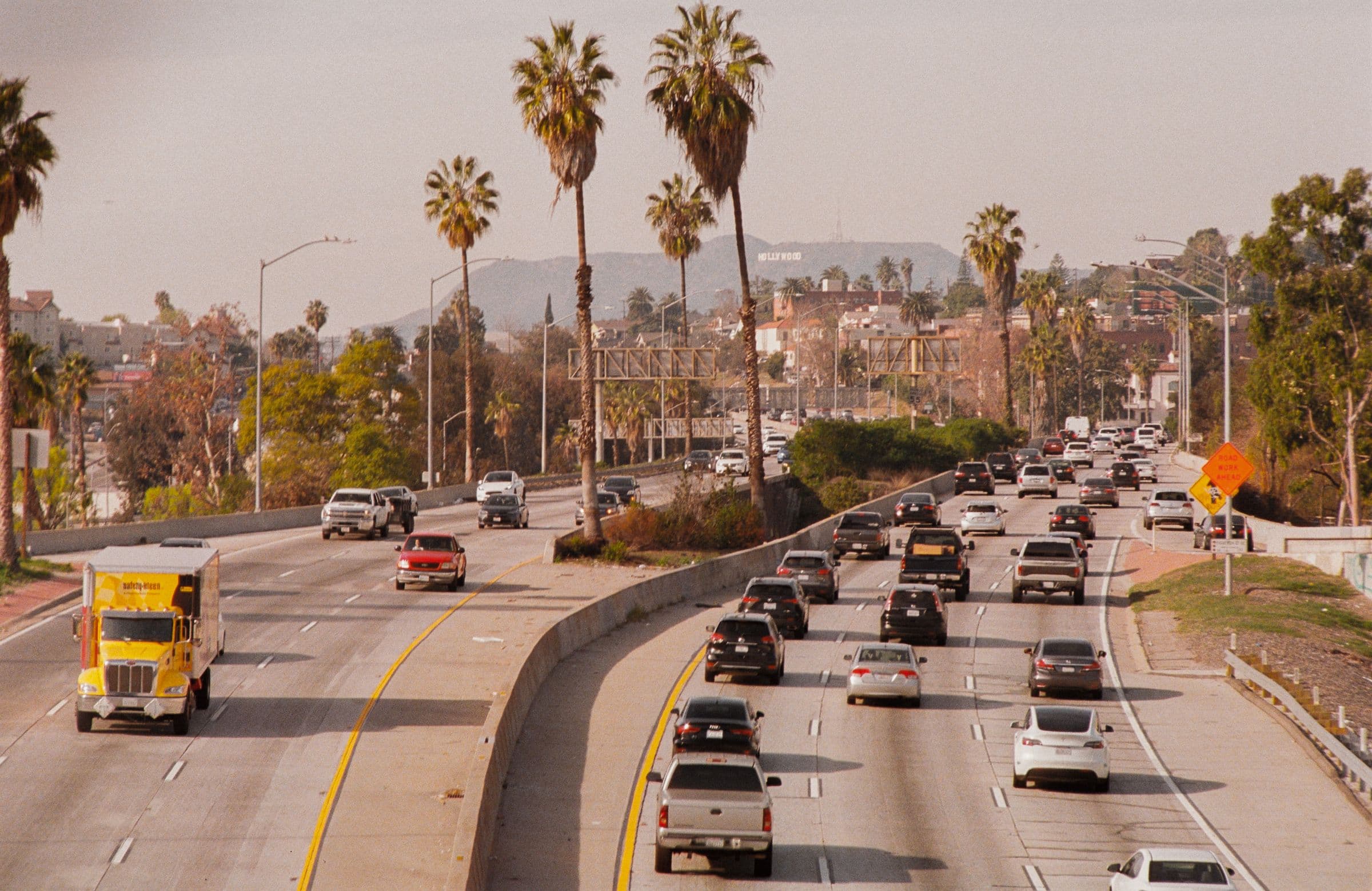 Traffic on a Los Angeles freeway lined with palm trees